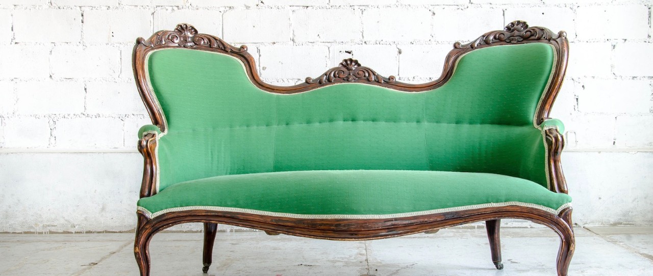 Green antique loveseat.